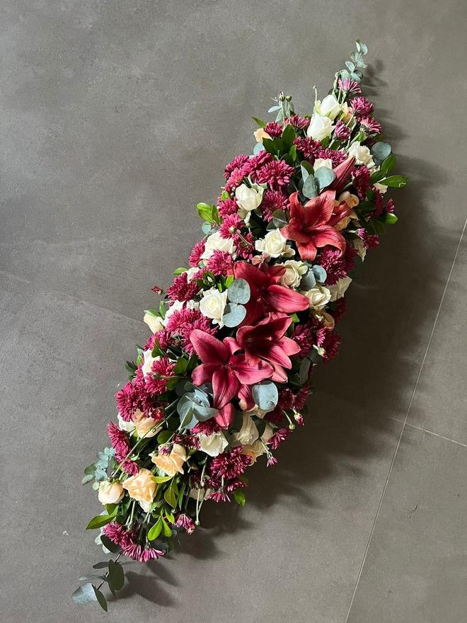Long floral car bonnet arrangement in pink and cream